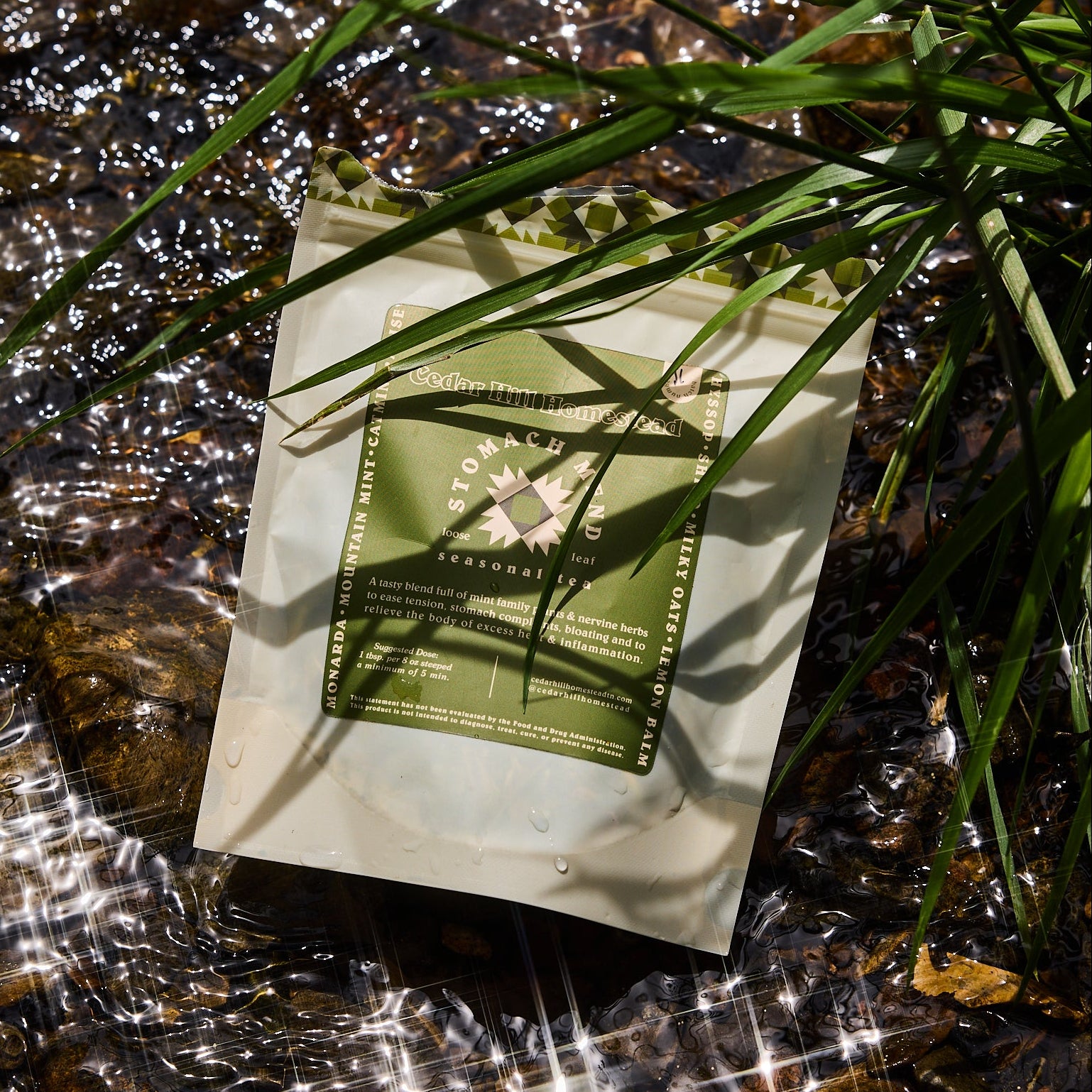 stomach mend tea by cedar hill homestead on a bed of water and grass